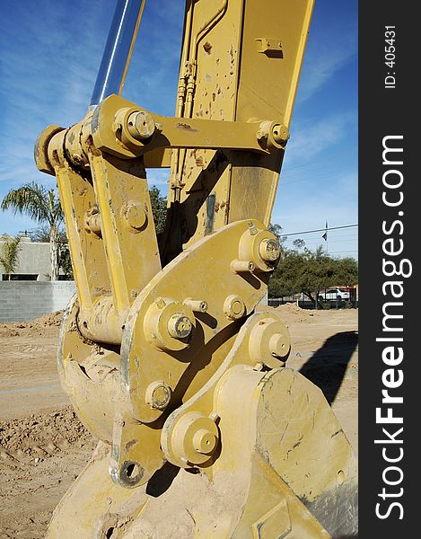 Backhoe equipment in a construction site in a residential area. Backhoe equipment in a construction site in a residential area.