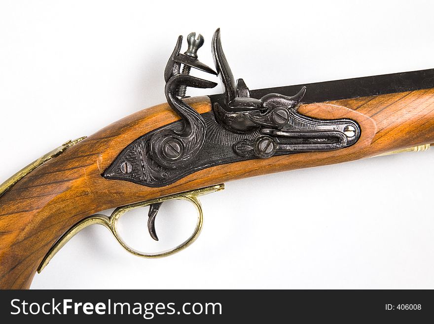 An antique pistol - trigger and flint view. An antique pistol - trigger and flint view
