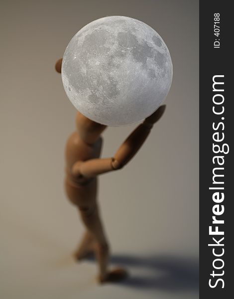Puppet carrying moon over grey