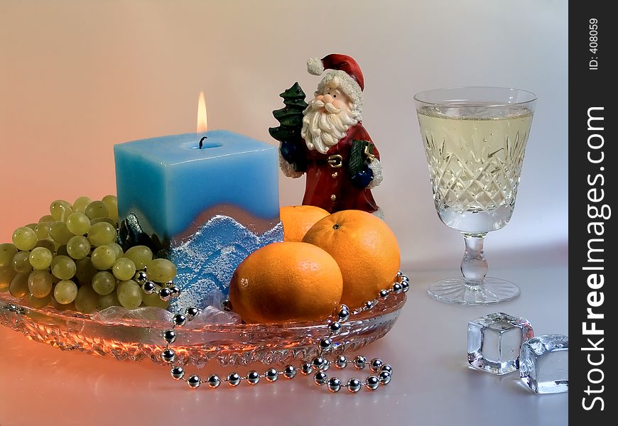Christmas composition with fruits, candle, Santa Claus and wineglass. Christmas composition with fruits, candle, Santa Claus and wineglass.