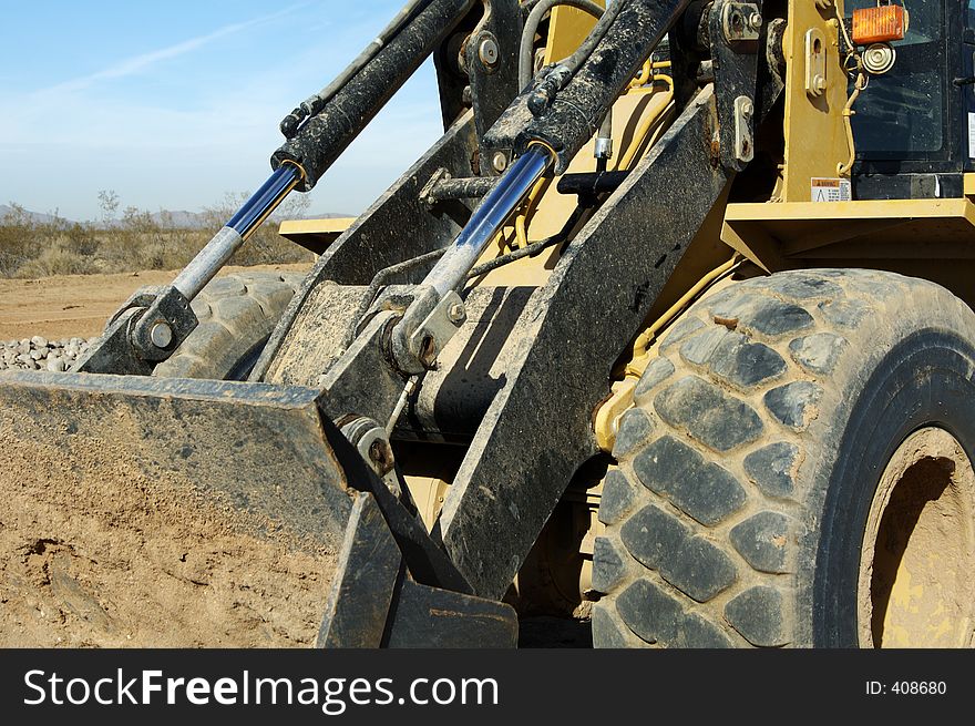 Front-end loader equipment in a construction site in a residential area. Front-end loader equipment in a construction site in a residential area.