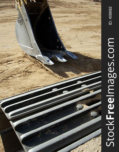 Front-end loader equipment in a construction site in a residential area. Front-end loader equipment in a construction site in a residential area.