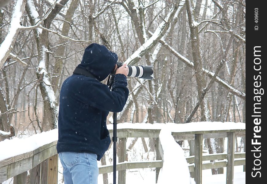 Photograph of a photographer taking photos on a snowy, winter day. Photograph of a photographer taking photos on a snowy, winter day.