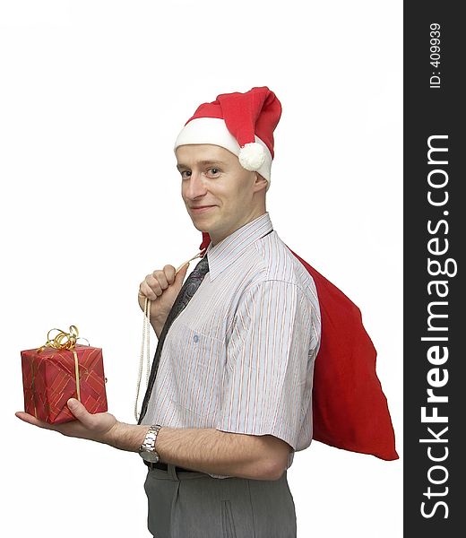 Young man wearing santa claus cap with red sack resting on his shoulder offering Christmas gift