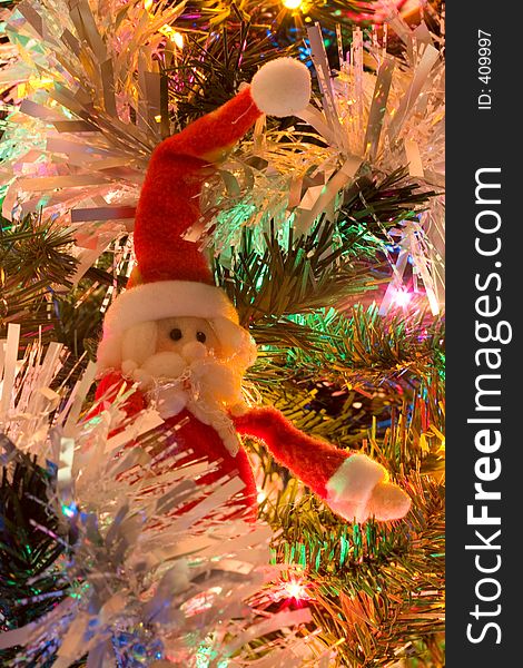 A bright Christmas tree section featuring a Santa Claus ornament. A bright Christmas tree section featuring a Santa Claus ornament.