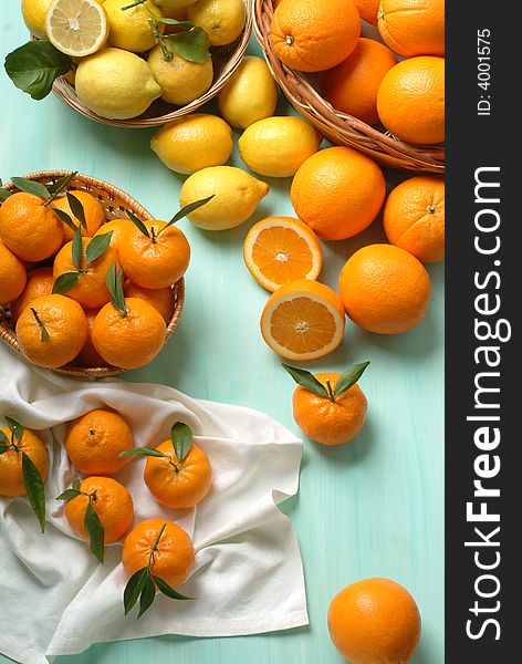 A group of fresh oranges, lemons and tangerines in a atable. A group of fresh oranges, lemons and tangerines in a atable