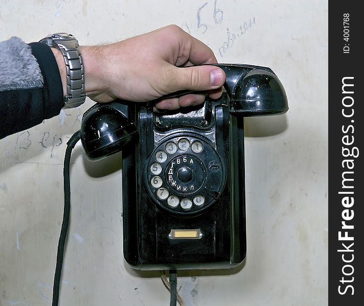 Hand holding a tube of old phone