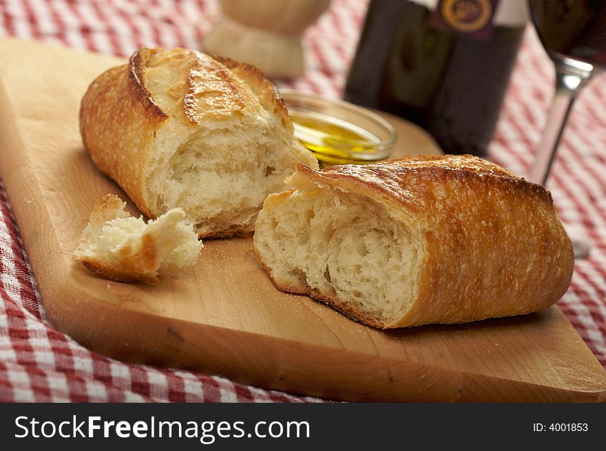 Sourdough Bread & Cutting Board on red & white checkered gingham - Narrow Depth of Field. Sourdough Bread & Cutting Board on red & white checkered gingham - Narrow Depth of Field