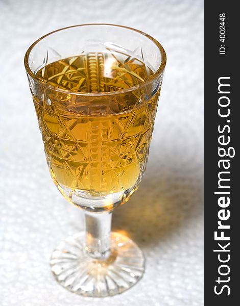 Crystal liqueur-glass with cognac at fancy cover