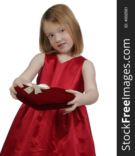 Young girl holding a heart valentine box of chocolates. Young girl holding a heart valentine box of chocolates
