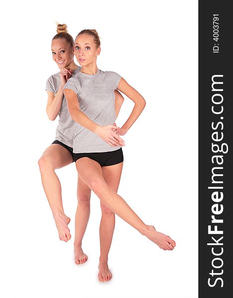 Twin sport girls posing balancing on white