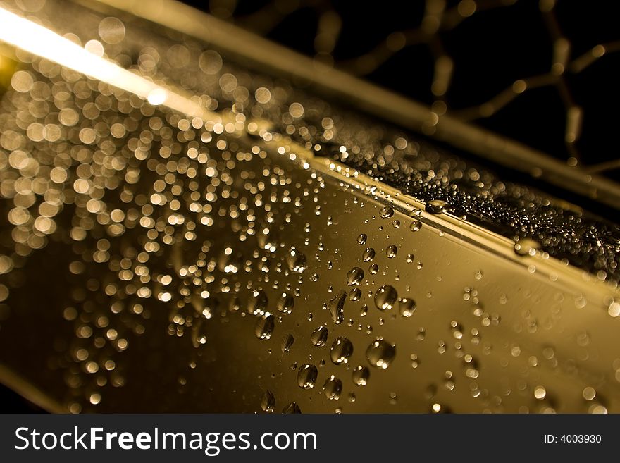 Abstract photo of water drops on a metal bumper. Abstract photo of water drops on a metal bumper