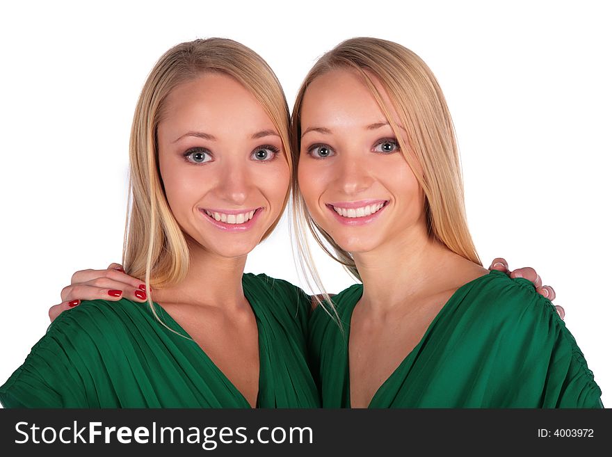 Twin girls embrace close-up on white