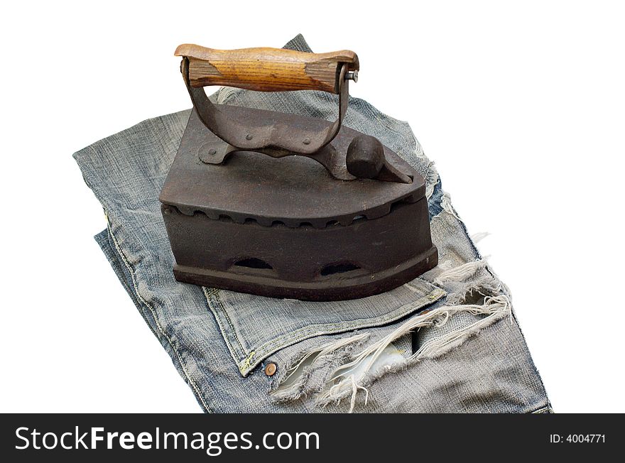 Old vintage flat-iron with jeans horizontal. Old vintage flat-iron with jeans horizontal