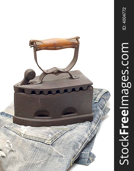 Old vintage flat-iron with jeans vertical. Old vintage flat-iron with jeans vertical