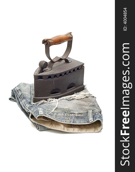 Old vintage flat-iron with jeans vertical. Old vintage flat-iron with jeans vertical