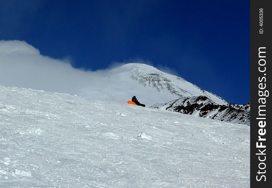 Snowboarder at the rest on the Ski Resort. Russia, Elbrus. Snowboarder at the rest on the Ski Resort. Russia, Elbrus