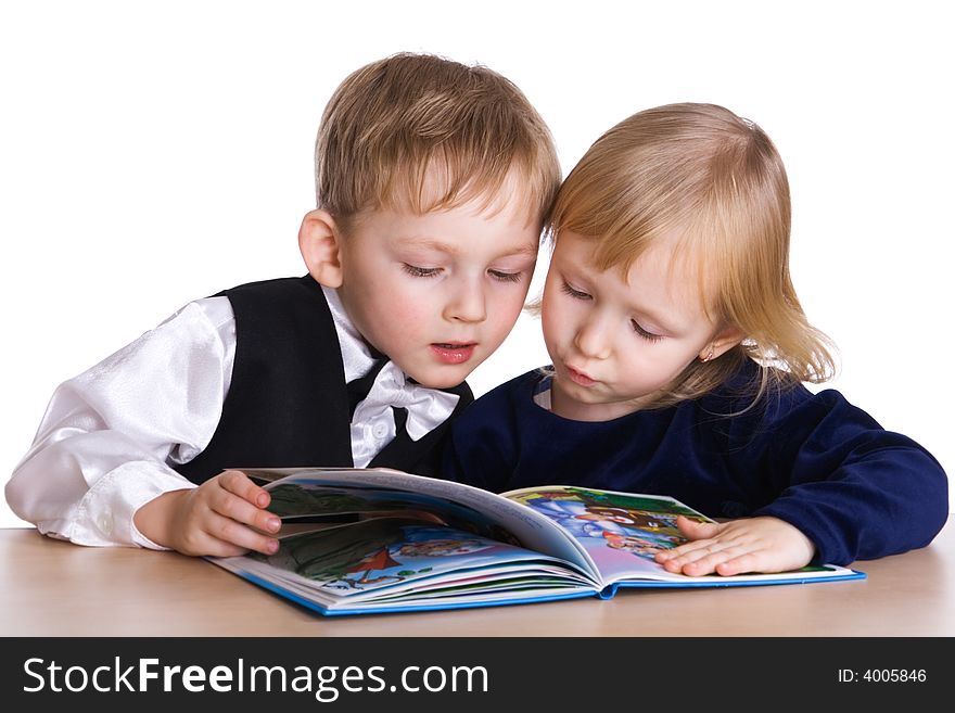 Young girl and boy look the book