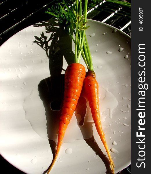 Orange carrots on the plate.