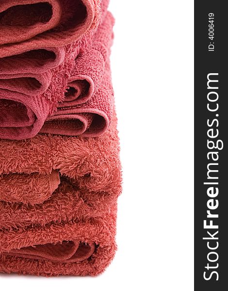 A stack of red bath towels against a white background