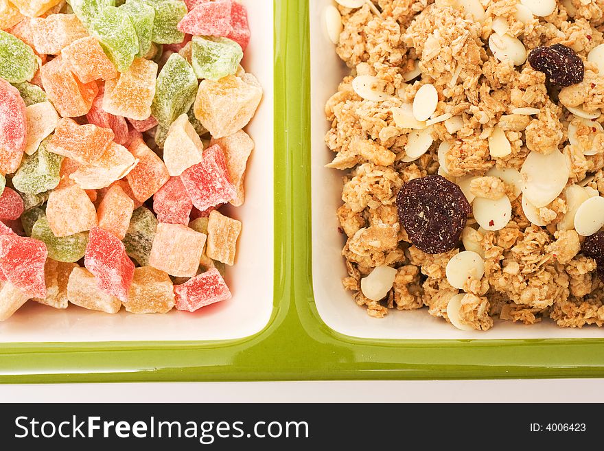 Muesli and candied fruits on white background. Healthy food image series