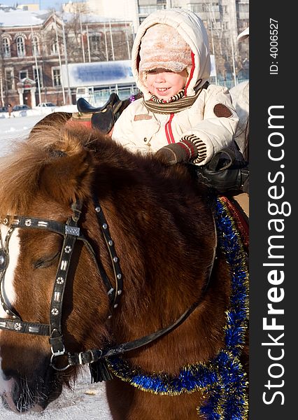 Boy and pony at the horse walk in winter time