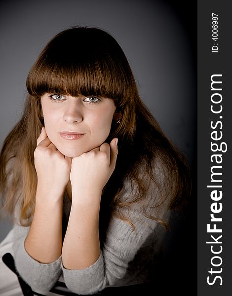 Portret of a nice girl on gray background in studio. Portret of a nice girl on gray background in studio