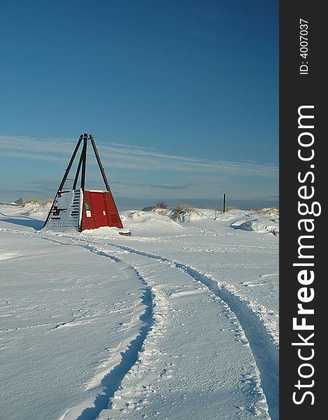 Car tracks in the snow by the beach. Car tracks in the snow by the beach