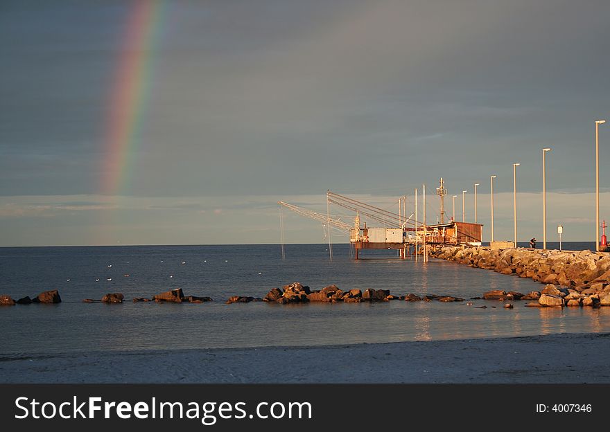 Rainbow at the coast in the sunset