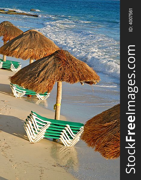 Beach green chairs , blue ocean and umbrellas