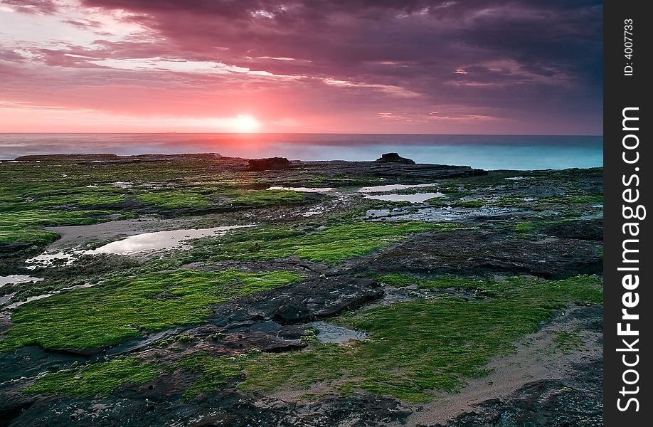 East coastline of Australia near Sydney, at sunrise, with a ship on the horizon. East coastline of Australia near Sydney, at sunrise, with a ship on the horizon