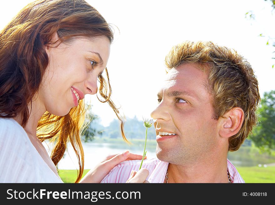A portrait of attractive couple in summer environment. A portrait of attractive couple in summer environment