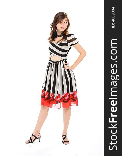 Standing woman in black and white stripes dress look side way. Standing woman in black and white stripes dress look side way