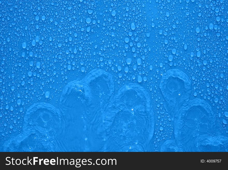 Water drops and streams over blue background