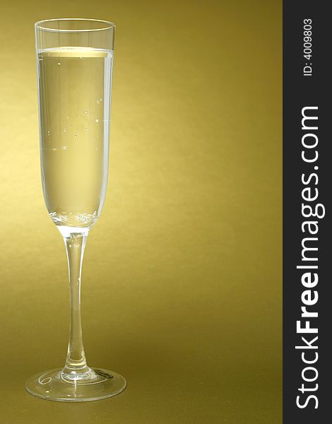 Flute of champagne on a golden background