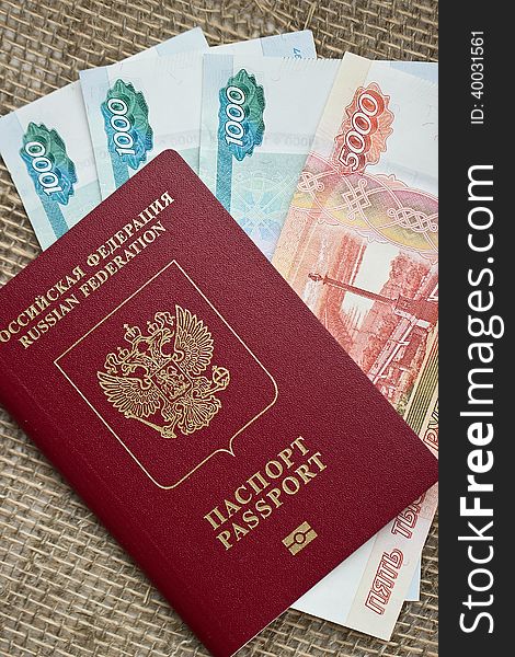 Russian passport with money on burlap background
