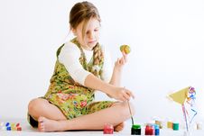 Young Girl Playing With Paint And Eggs Stock Images