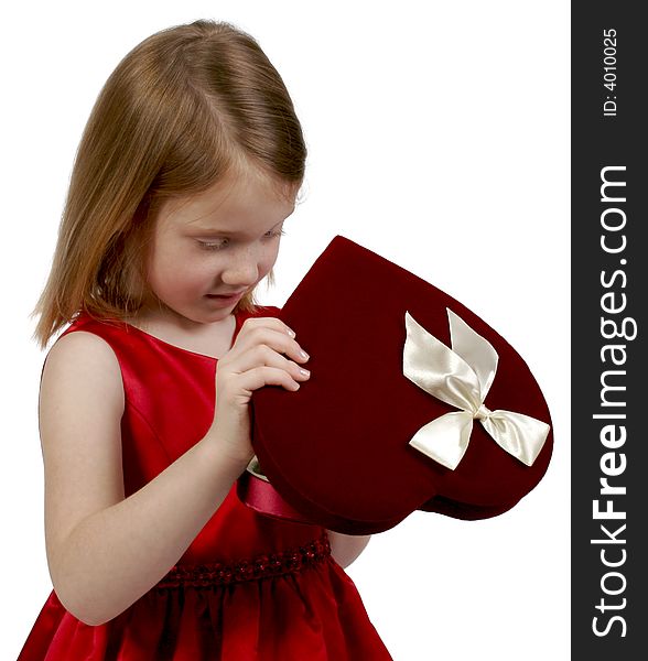 Young girl holding a heart valentine box of chocolates. Young girl holding a heart valentine box of chocolates