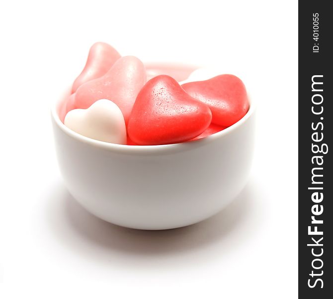 Bowl of heart shaped candy isolated on a white background. Bowl of heart shaped candy isolated on a white background