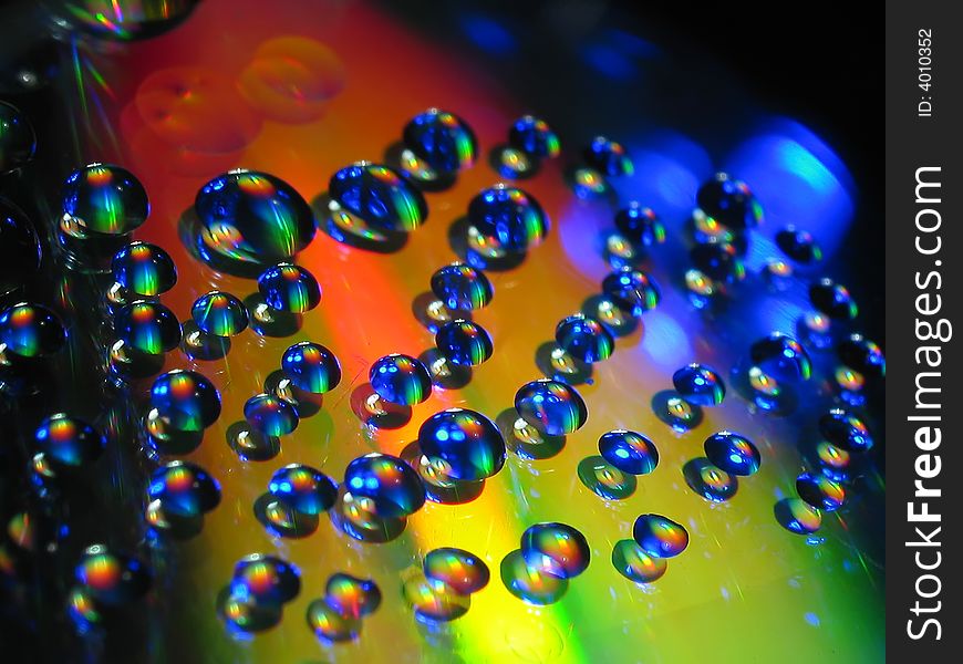 Macro picture of water drops on a cd disc.