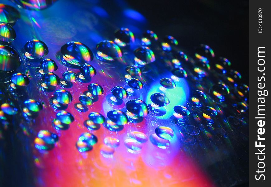 Macro picture of water drops on a cd disc.