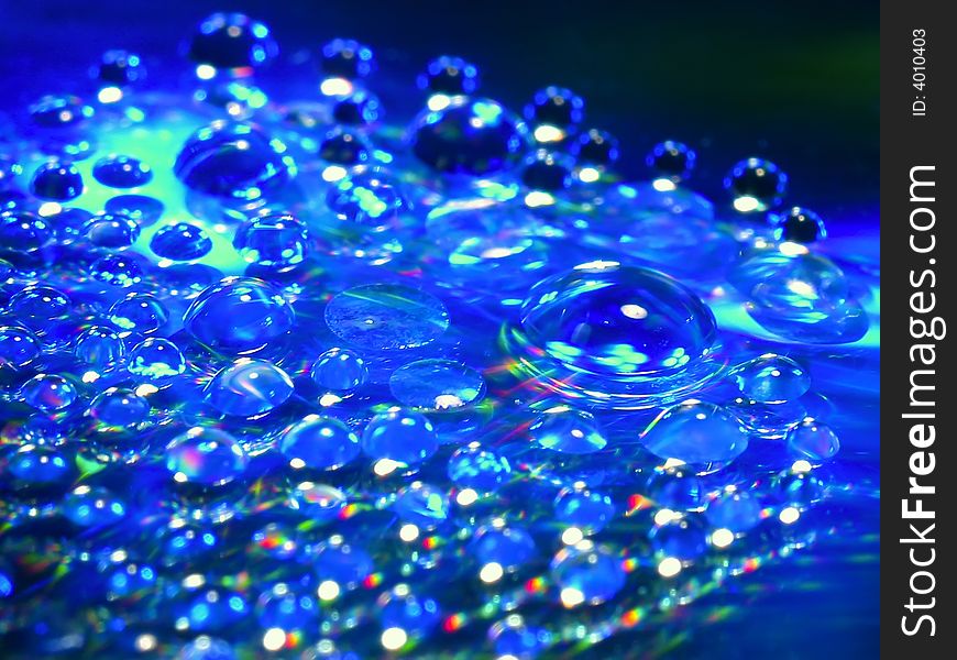 Macro picture of water drops on a cd disc.