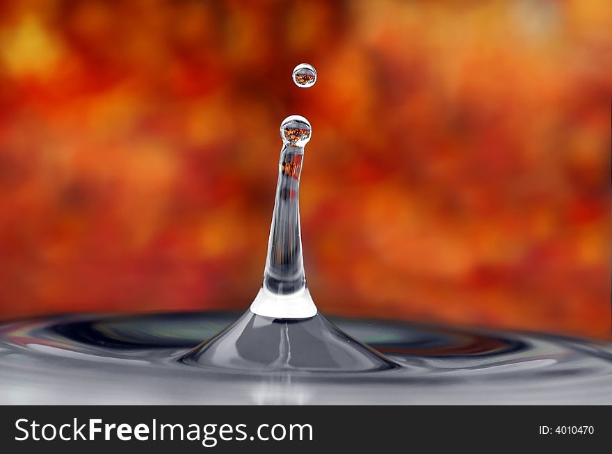 Isolated tower of water and droplet in an autumn environment