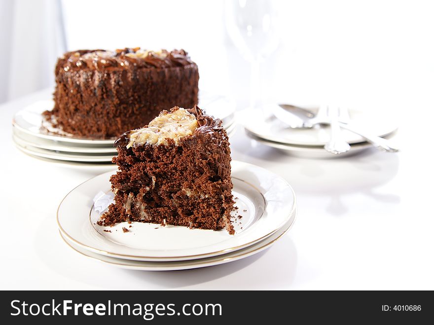 German Chocolate Cake slice with whole cake in background.