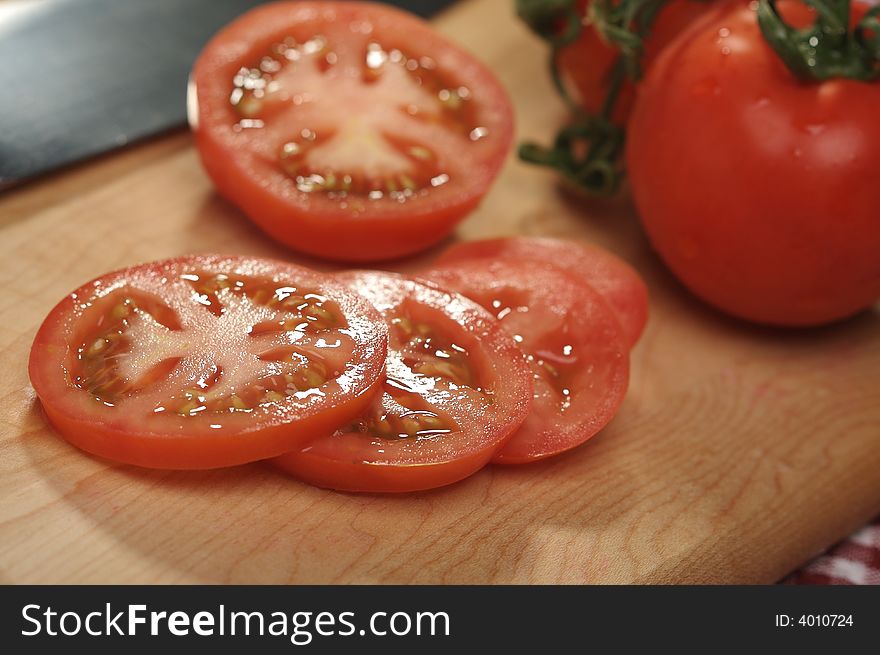 Fresh Cut Tomato on a Cutting Board & red & white checkered gingham