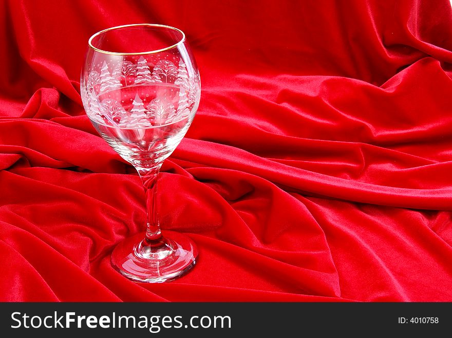 Empty wine glass on red velvet