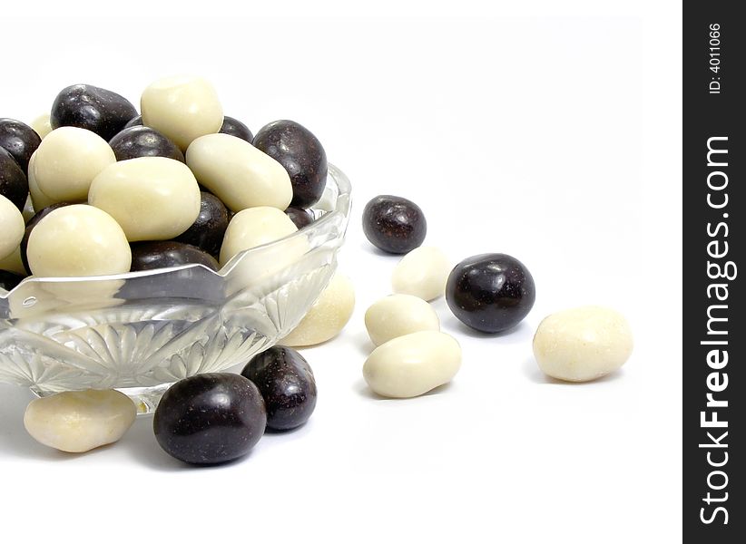 Group of black and white sweet candies isolated over white background