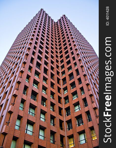 A photograph of a tall, red building at Tokyo's business district