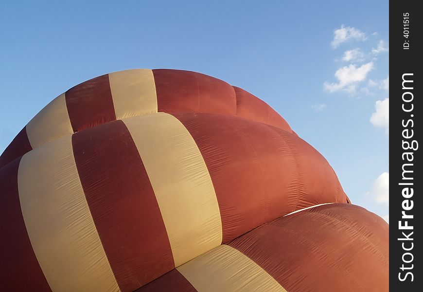 Detail of brown and beige hot-air balloon, halfway inflated. Detail of brown and beige hot-air balloon, halfway inflated.