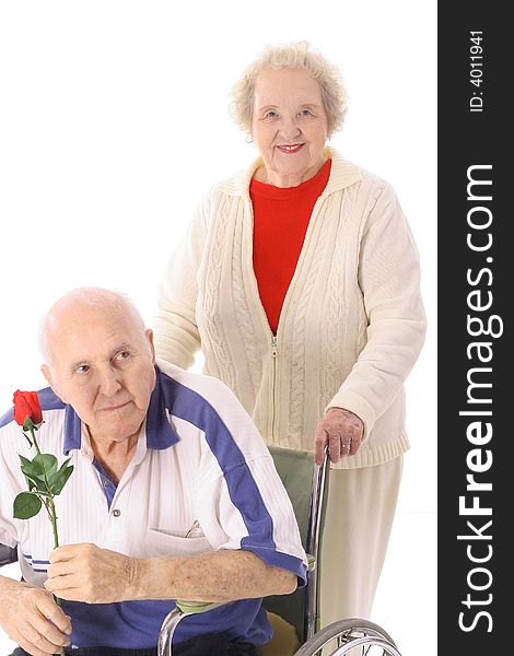 Wife pushing elderly husband isolated on white